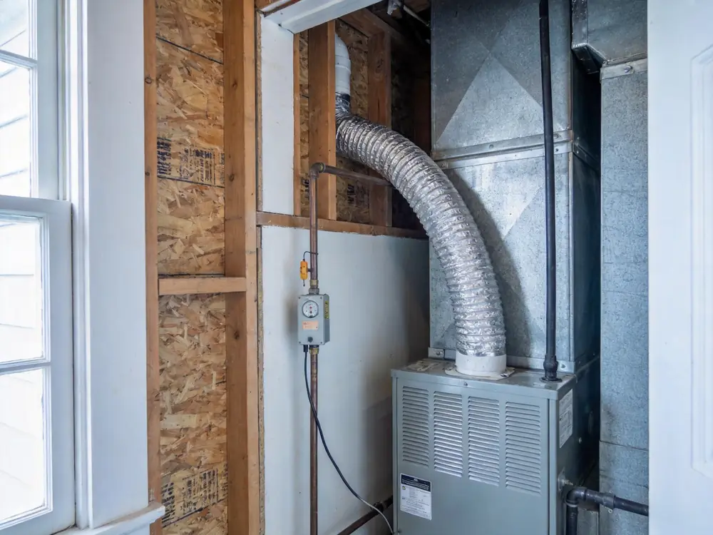 Condensate drain line and float switch beside an air handler