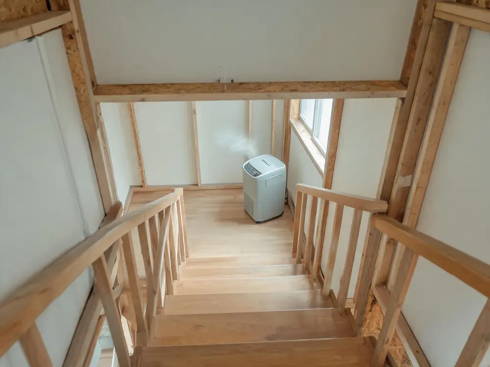 Dehumidifier running on the landing of an apartment stairwell
