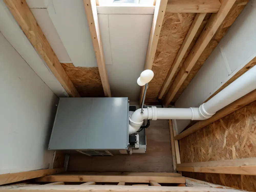 Condensate drain line and float switch beside an air handler