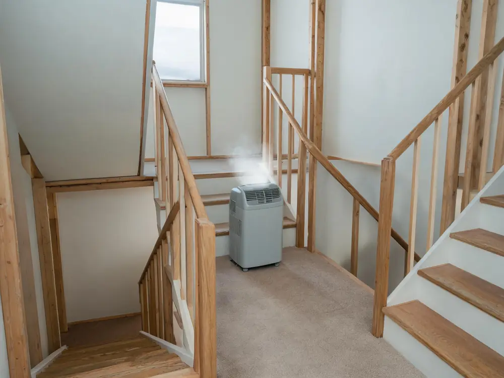 Dehumidifier running on the landing of an apartment stairwell