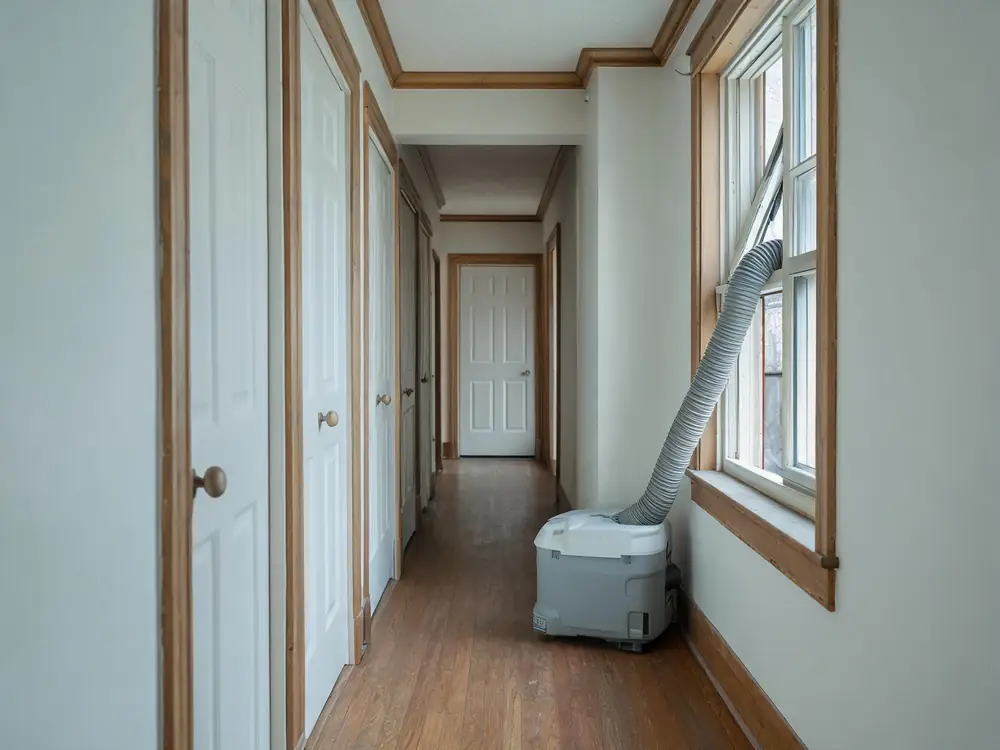Air scrubber ducted through a window in a rental corridor